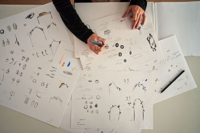 Cropped designer drawing collection of accessories