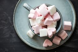 Top view of St. Valentines concept with marshmallow overflowing from mug