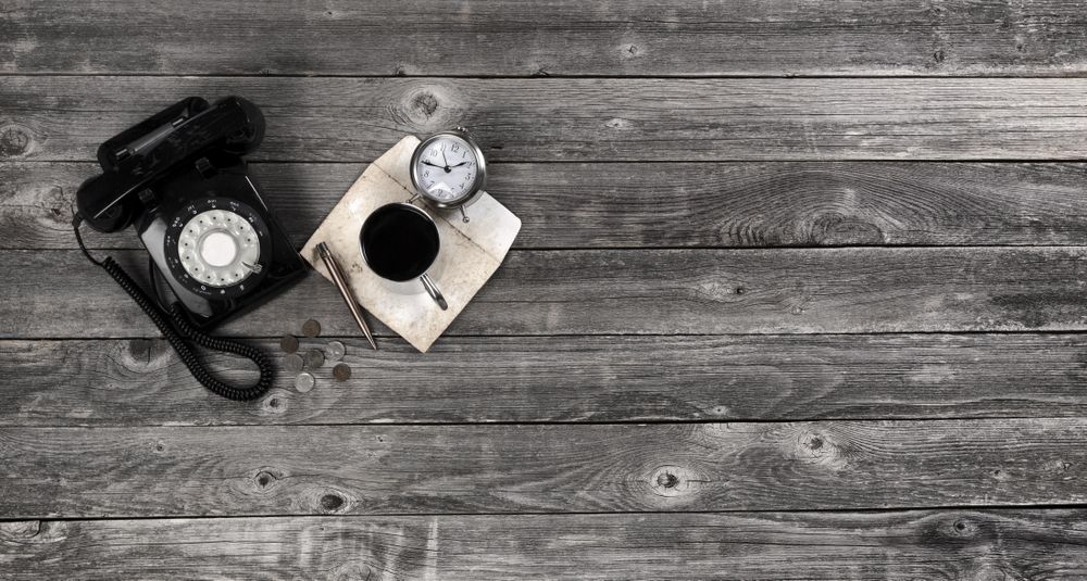 Old wooden desk table with retro business things