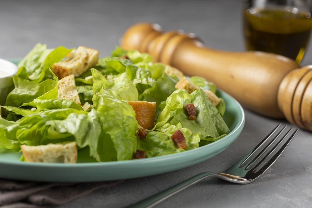Caesar salad with croutons and bacon.