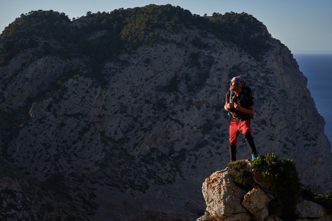 Male hiker admiring picturesque mountains