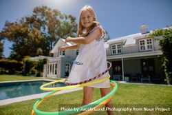 Beautiful little girl having fun with hula hoops outdoors bY1EYb
