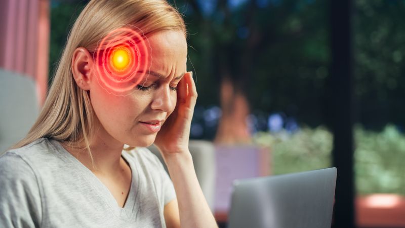 VFX Headache Render: Close Up of a Female Working on Laptop Computer and Experiencing Discomfort and Migraine.