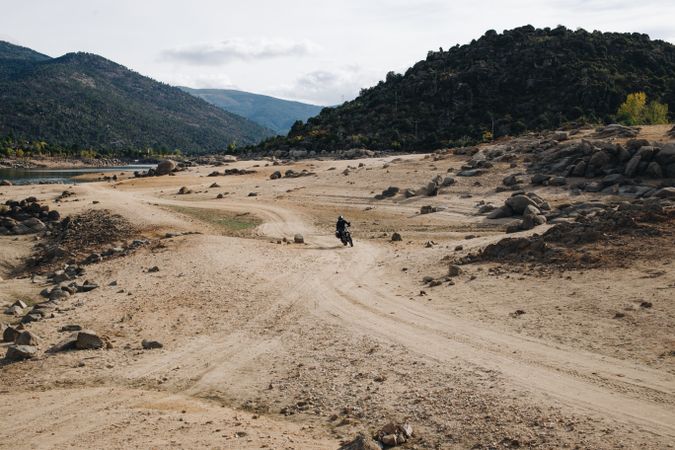 Person riding motorcycle on isolated country road