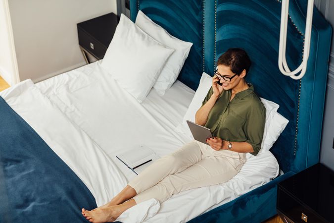 Businesswoman working on hotel bed