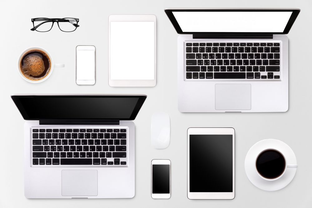 Laptop tablet smartphone eyeglass and coffee on wood table background with text space and copy space