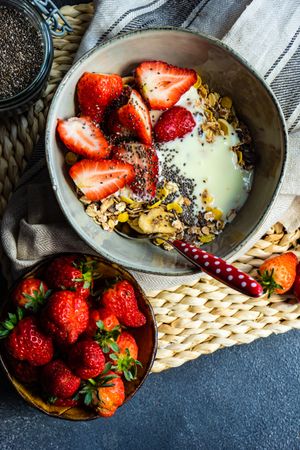 Top view of healthy breakfast concept with oatmeal, chia seeds and strawberry