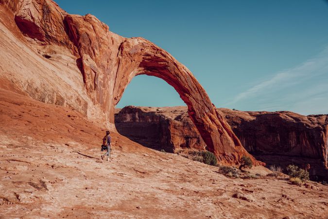Woman  hiking near Corona Arch in Moab, Utah, USA