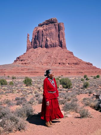 Navajo woman in front of Monument Valley mitten rock
