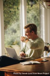 Man enjoying coffee while working from home 5okKG5