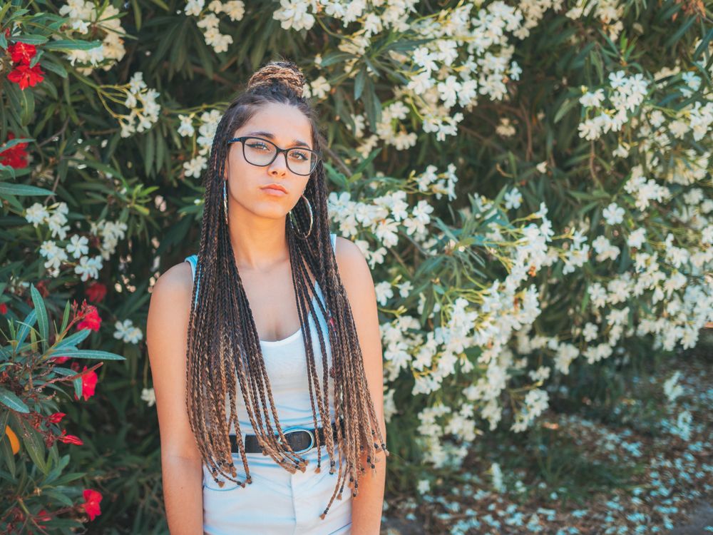 young female standing near blooming trees