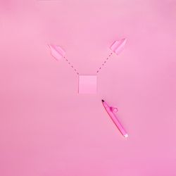 Pen and post it notes on pink background