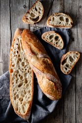 Fresh baguettes on checkered towel