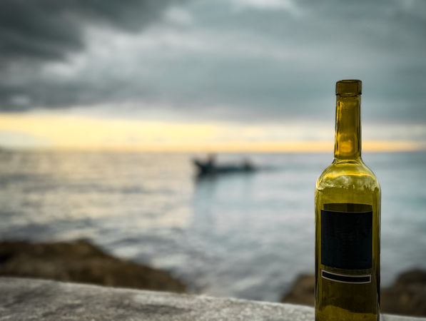 Bottle of wine with ocean in the background