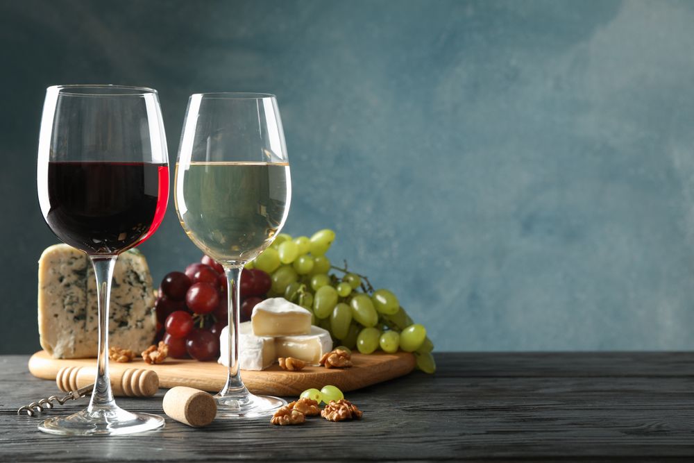 Grape, cheese, corkscrew, glasses with wine, on wooden background, copy space