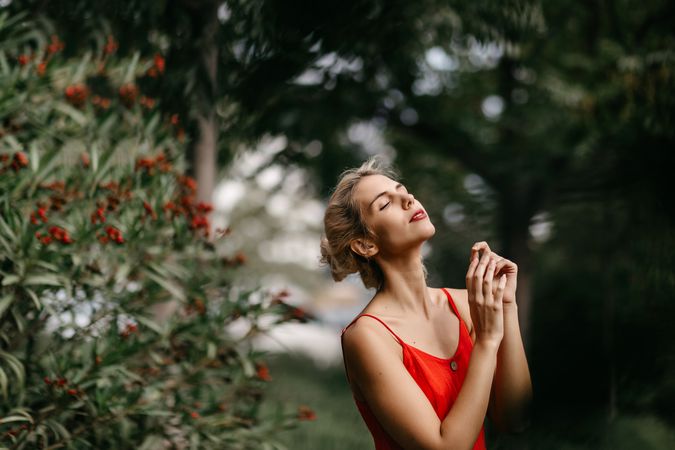 Dreamy young woman in summer garden