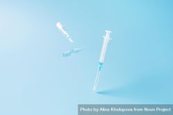 Medical syringes on blue background with copy space 0vVDx0