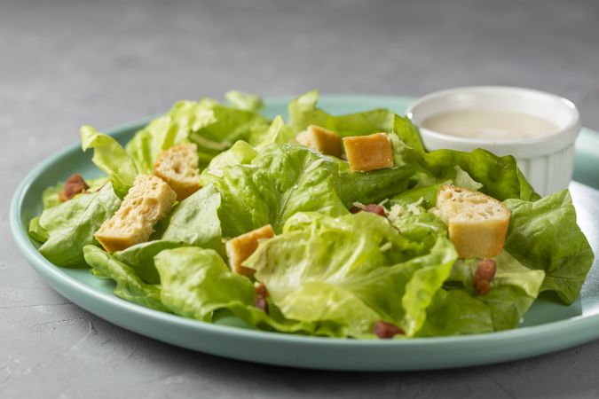 Caesar salad with croutons and bacon.