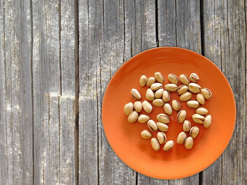 Pistachios On The Wooden Background