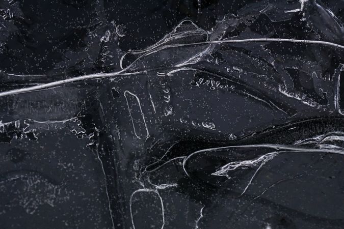 Fragment of thin ice on dark frozen river