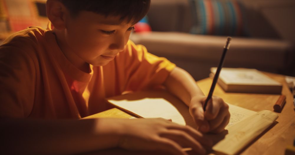 Focused Kid Learning, Studying for best Grades, Writing Lesson Answers.