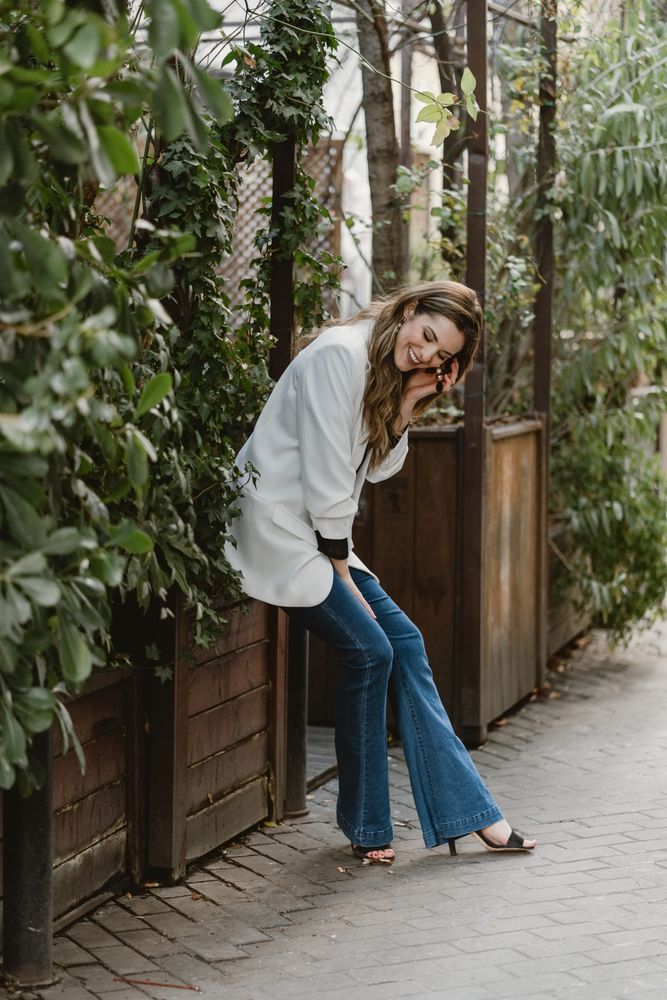 Woman sitting on planter in garden