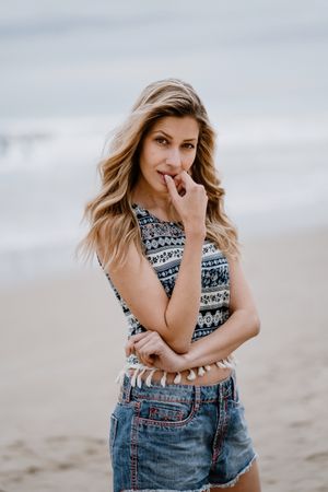 Happy female posing on sandy beach