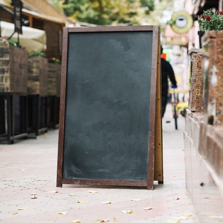 Blank chalk board near cafe