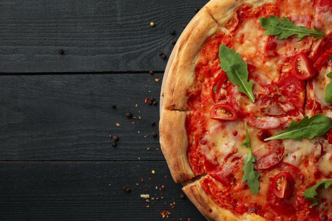 Tasty pizza on wooden background, top view