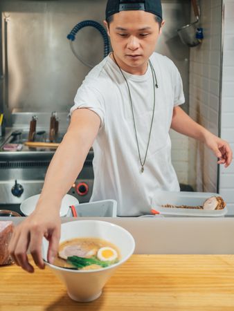 Asian chef with served bowls of ramen