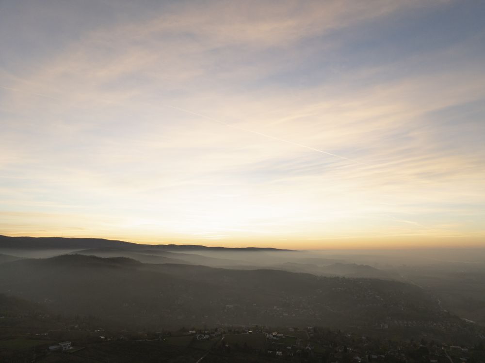Tranquil Sunrise Over Misty Hills and Rural Valley.