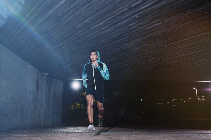 Young man jogging at night