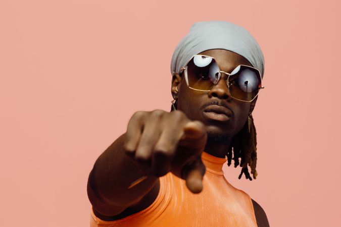 Black male looking at camera pointing finger to spectator wearing sunglasses
