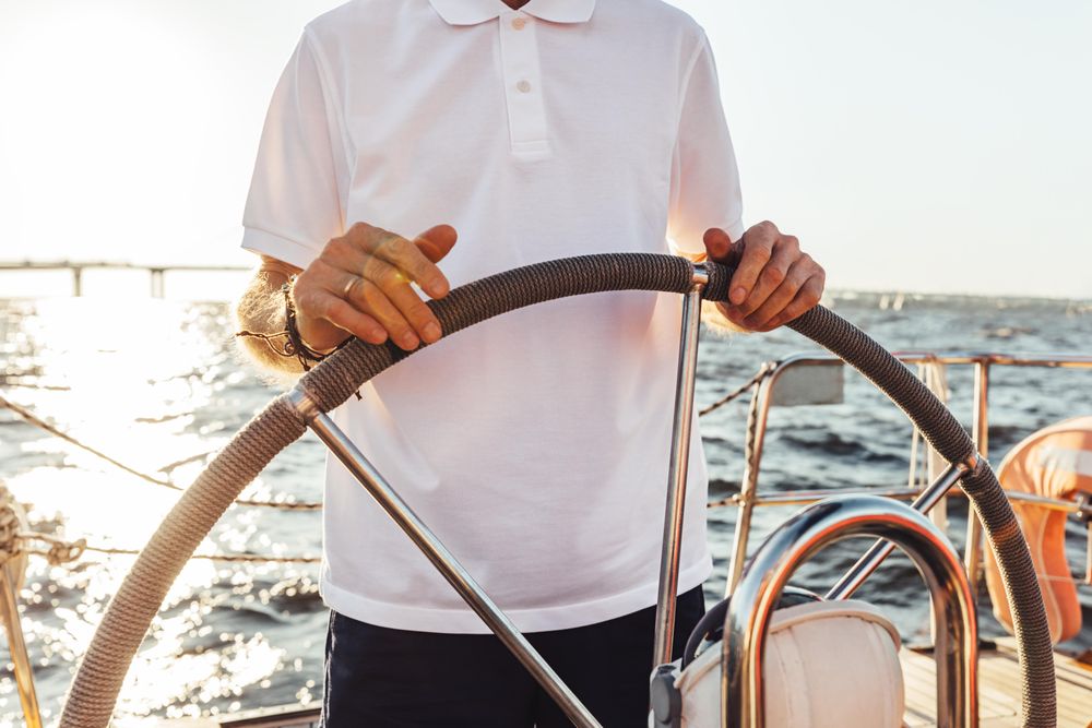 Man at helm of a boat