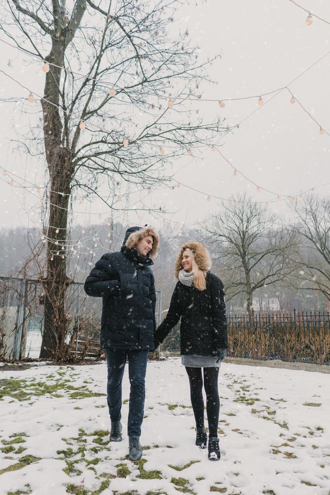 Smiling couple holding hands while walking on the street