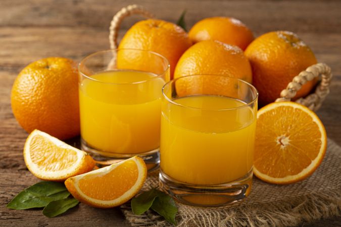 Glass with orange juice on the table.