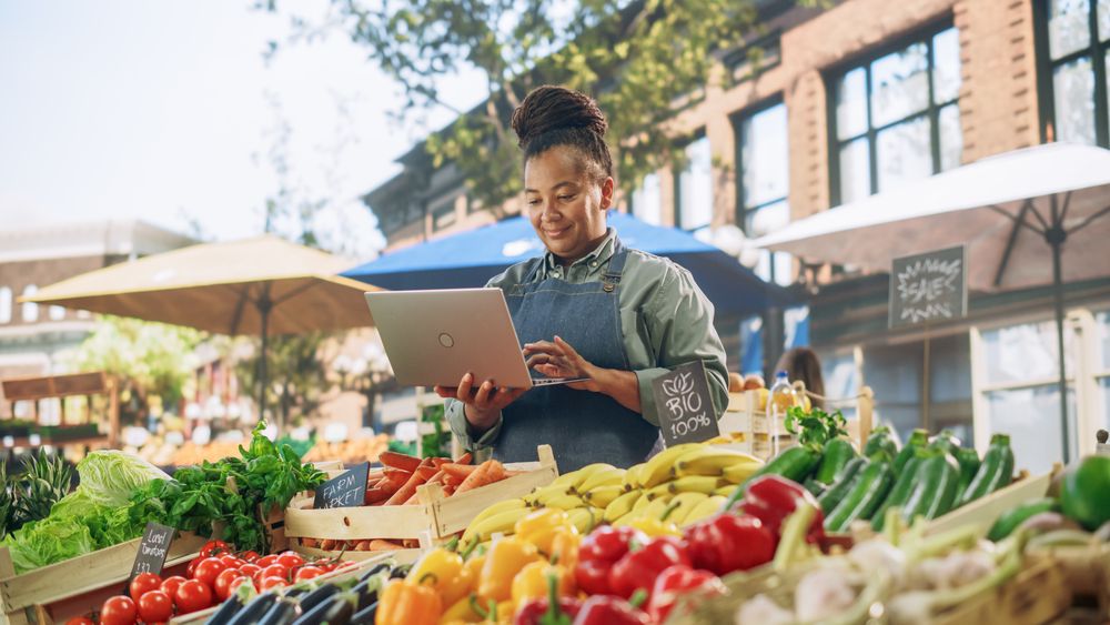 Portrait of a Black Female Running a Street Vendor Food Stand with Fresh Organic Agricultural Products.