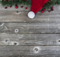 Santa cap with fir branches on old wood