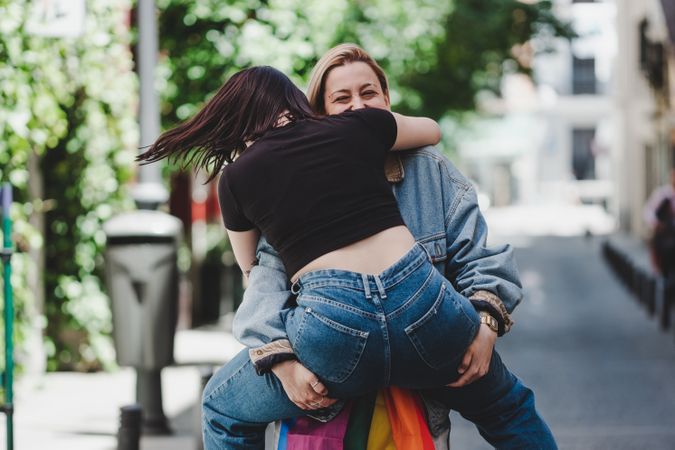 Happy lesbian couple having fun on street