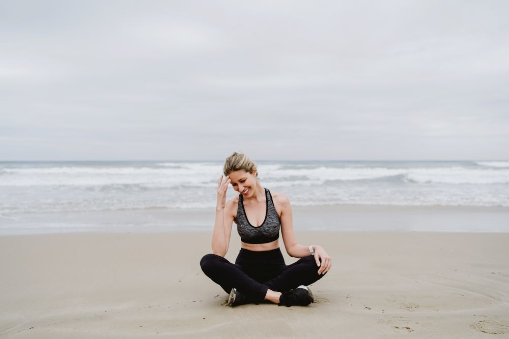 Woman meditating on the beach