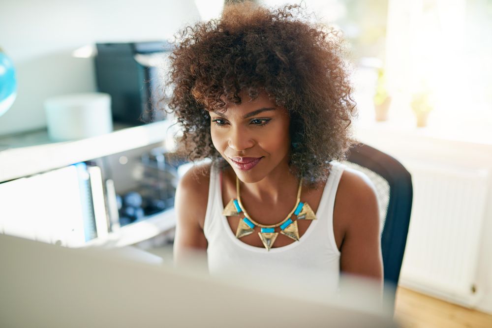 Female business owner working on computer in her home office