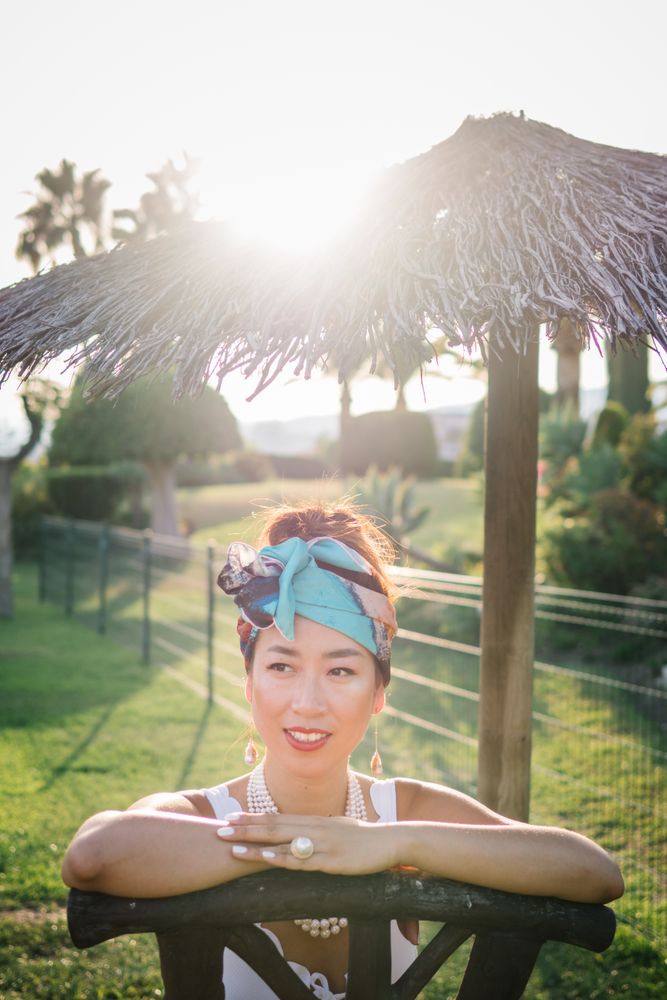 Young elegant chinese woman sunbathing