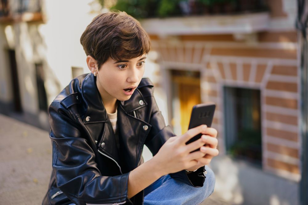 A Young Person Reacting Emotionally to Surprising Content on Their Mobile Device