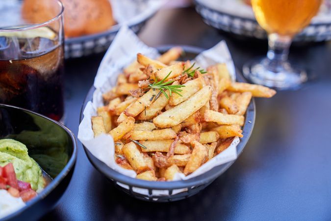 Delicious French Fries in basket placed on table