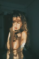 Portrait of woman in gray bra standing indoor