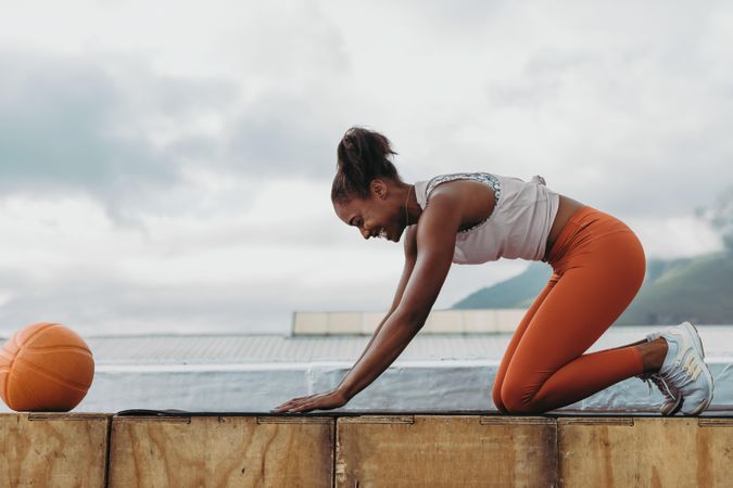 Sportswoman practicing yoga on rooftop