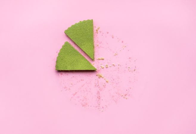 Slices of green matcha cheesecake with leftover crumbs
