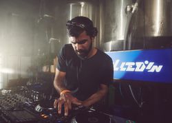 London, England, United Kingdom - Nov 9, 2022: Male DJ looking down as he mixes