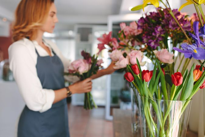 Female florist unfocused in flower shop