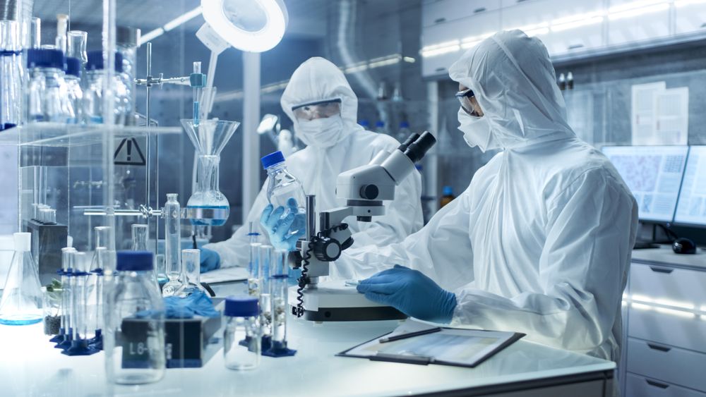 In a Secure High Level Laboratory Scientists in a Coverall Conducting a Research.